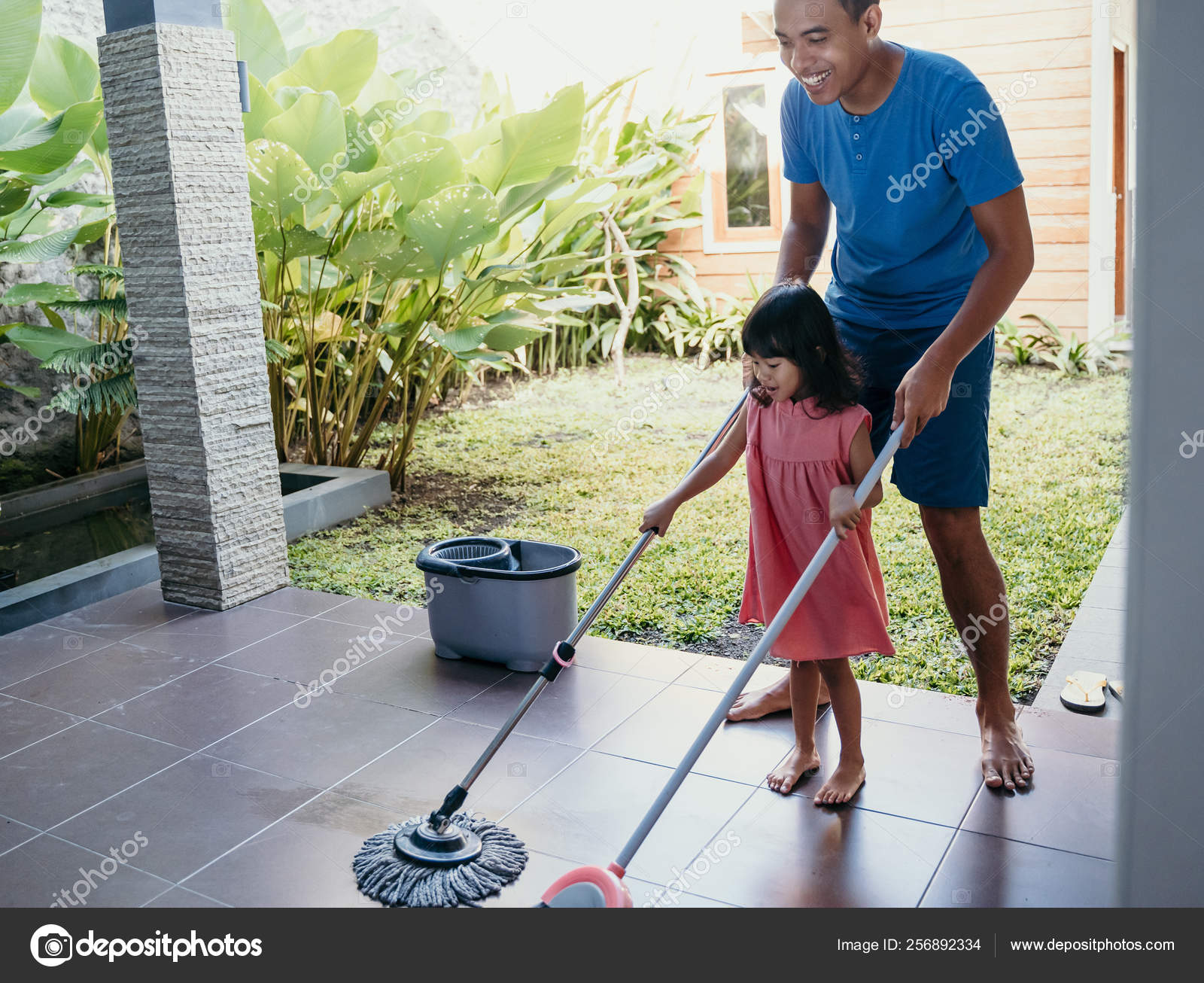Little girl help her daddy to do chores Stock Photo by ©odua 256892334