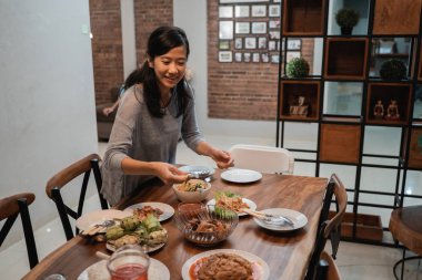 house wife preparing table for dinner