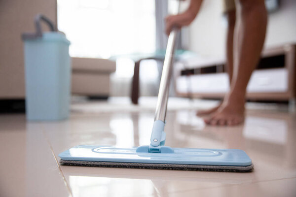man with mop to cleaning floor
