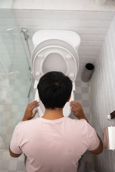 Männchen kotzt auf Toilette — Stockfoto