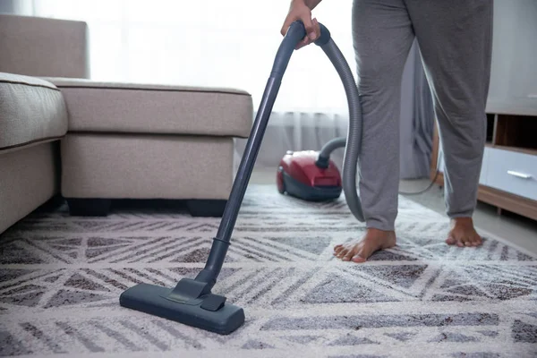 Man hand vacuuming carpet — Stock Photo, Image