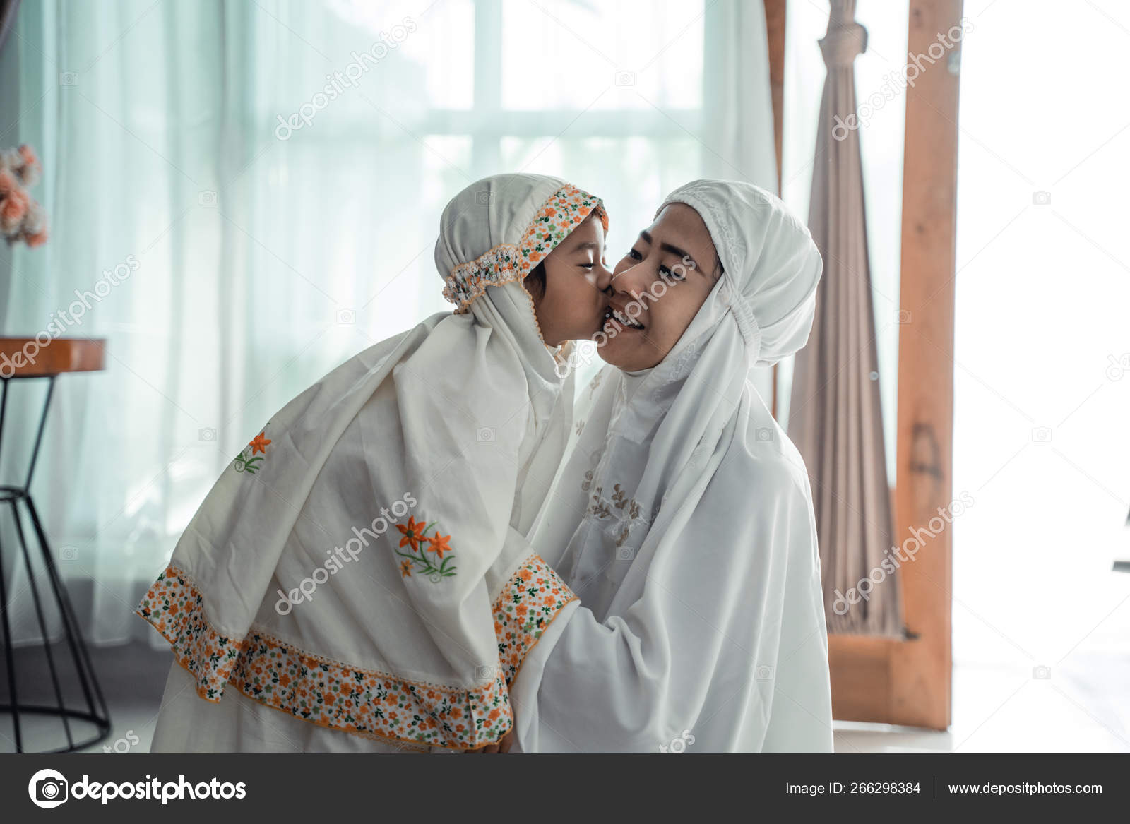 Muslim young child kiss her mom after praying — Stock Photo © odua