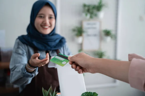 worker in cafe counter receiving payment