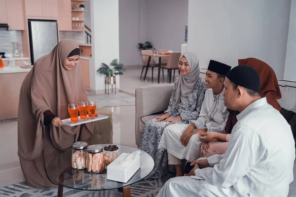 Woman holding a glass of sweet drink for break fasting with family — Φωτογραφία Αρχείου