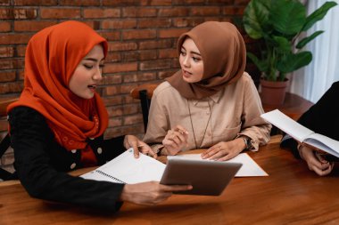 Hijab women chatting with friends about university assignments