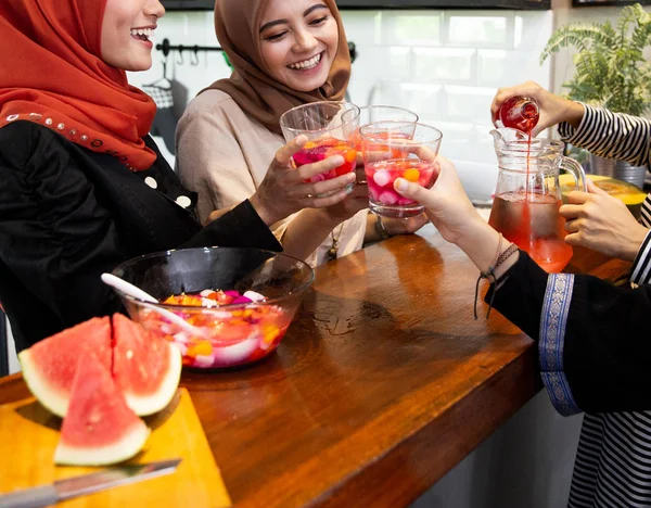 hijab women and friends breaking fast with sweet drinks