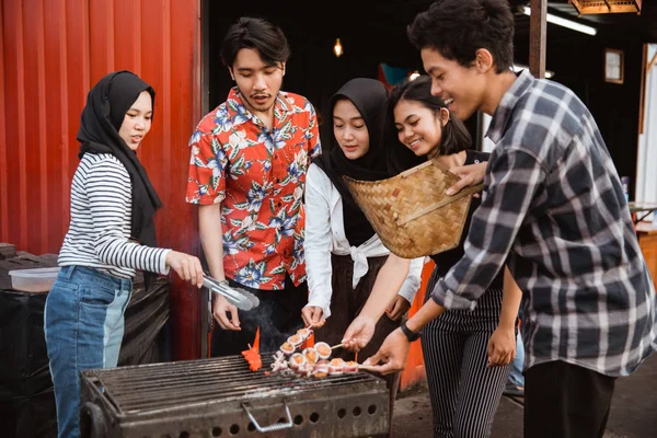 Groupe d'amis griller la nourriture avec une brochette — Photo