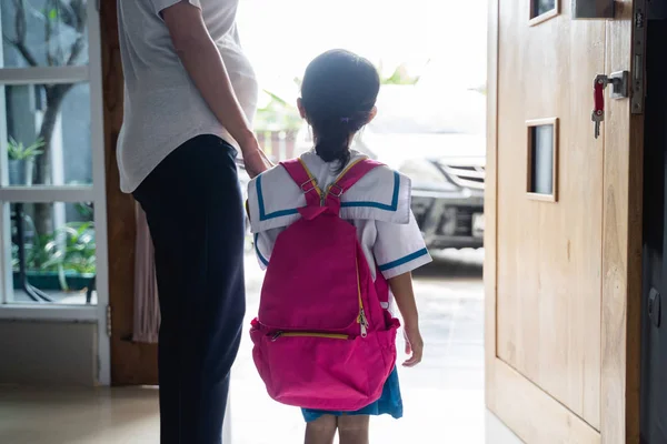Sırt çantası ile küçük kızının elini tutarak anne — Stok fotoğraf