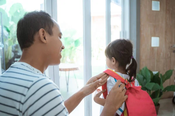 Vader helpen om rugzak te zetten op haar dochter — Stockfoto