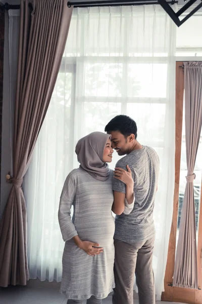 Беременность мусульманская женщина с мужем — стоковое фото