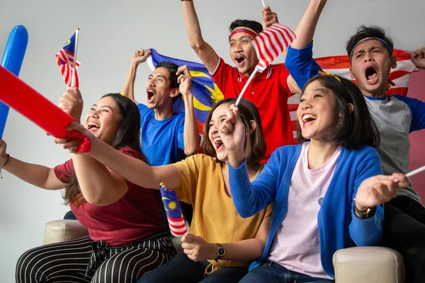 people holding malaysia flag celebrating independence day