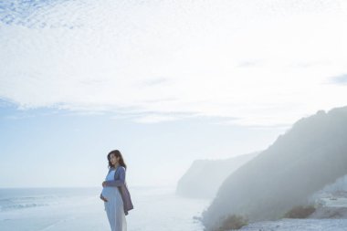 hamile anne bir uçurumun yanında duruyor