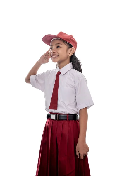 Студент дає вітання під час виховання прапора Індонезії — стокове фото