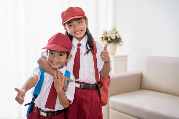 Primary student wearing school uniform showing thumbs up — Stock Photo, Image