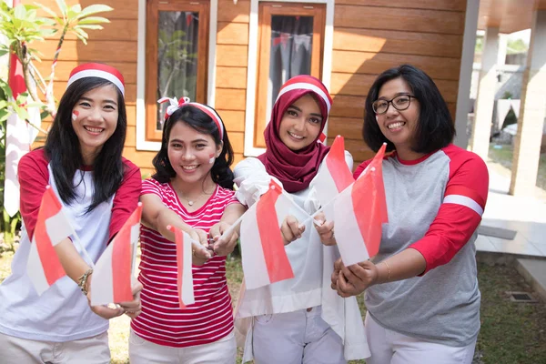 indonesian woman with flag celebrating independence day