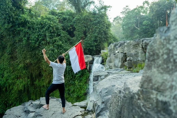 Asijský muž s indonéskou vlajkou oslavující den nezávislosti — Stock fotografie