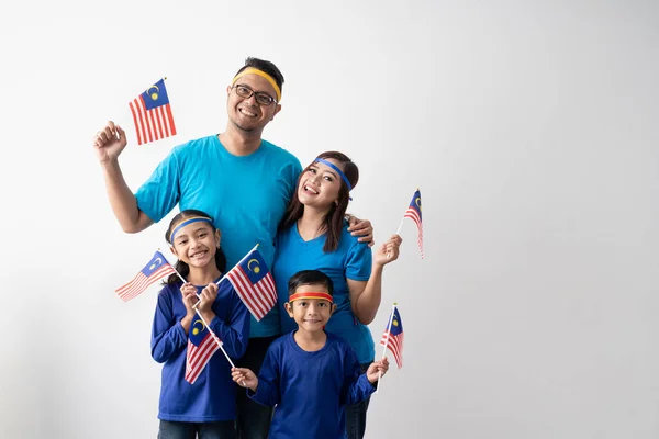 malaysia family with attributes and flag celebrating