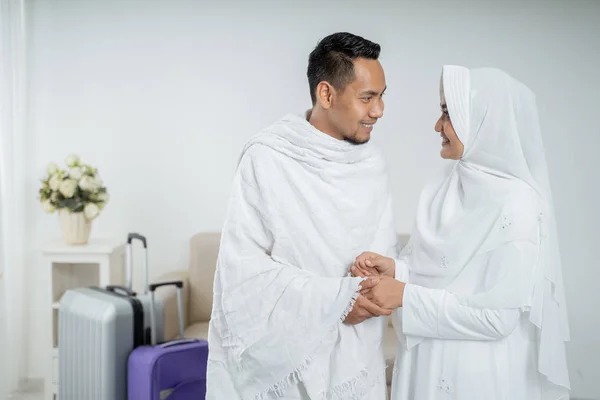 muslim pilgrims wife and husband in white traditional clothes