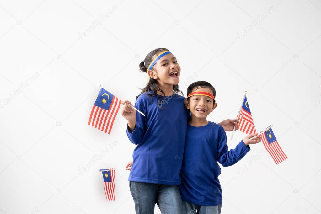 cute kids holding malaysian flag over white background