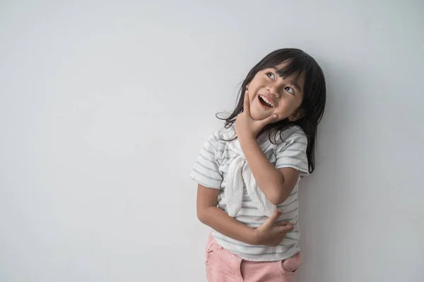 Asian cute little girl surprised looking up — Stock Photo, Image