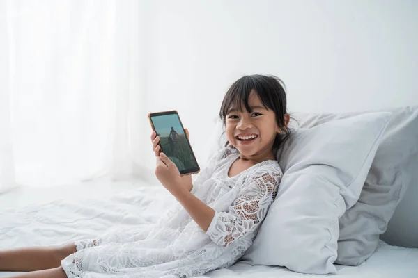 Asiatische Tochter spielen Spiele auf Ihr Handy — Stockfoto