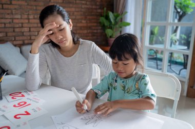 unhappy mother while teaching her daughter at home clipart