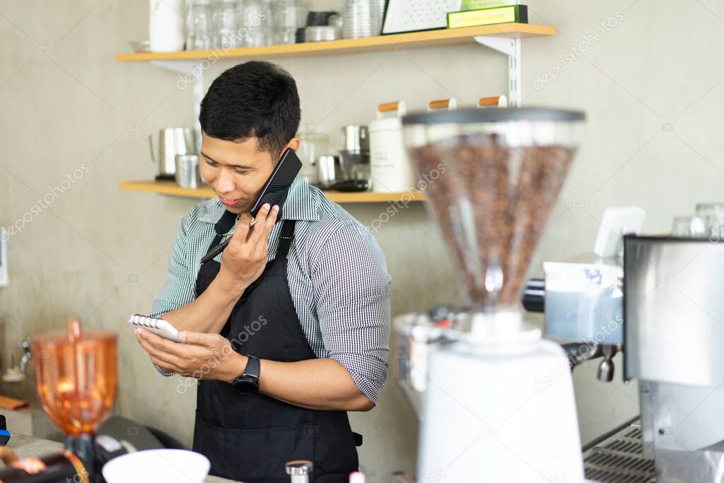 male barista calling using smartphone