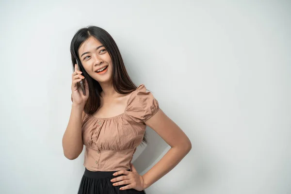 Hezká dívka s dlouhými vlasy úsměv při volání pomocí chytrého telefonu — Stock fotografie