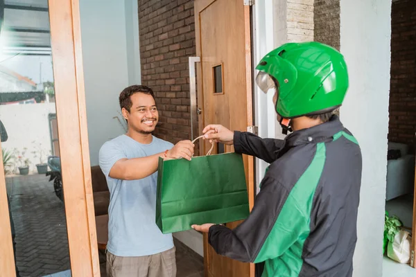 man delivery service uber send shopping bag