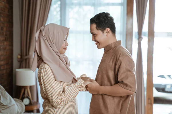 stock image young Muslim couple smiling happily facing each other holding hands