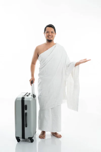 Aziatische man met ihram presenteren copyspace — Stockfoto