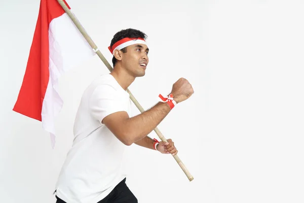Animado masculino segurando indonésia bandeira — Fotografia de Stock