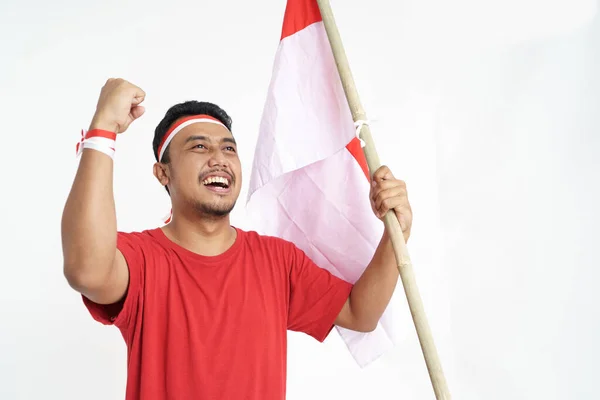 Animado masculino segurando indonésia bandeira — Fotografia de Stock