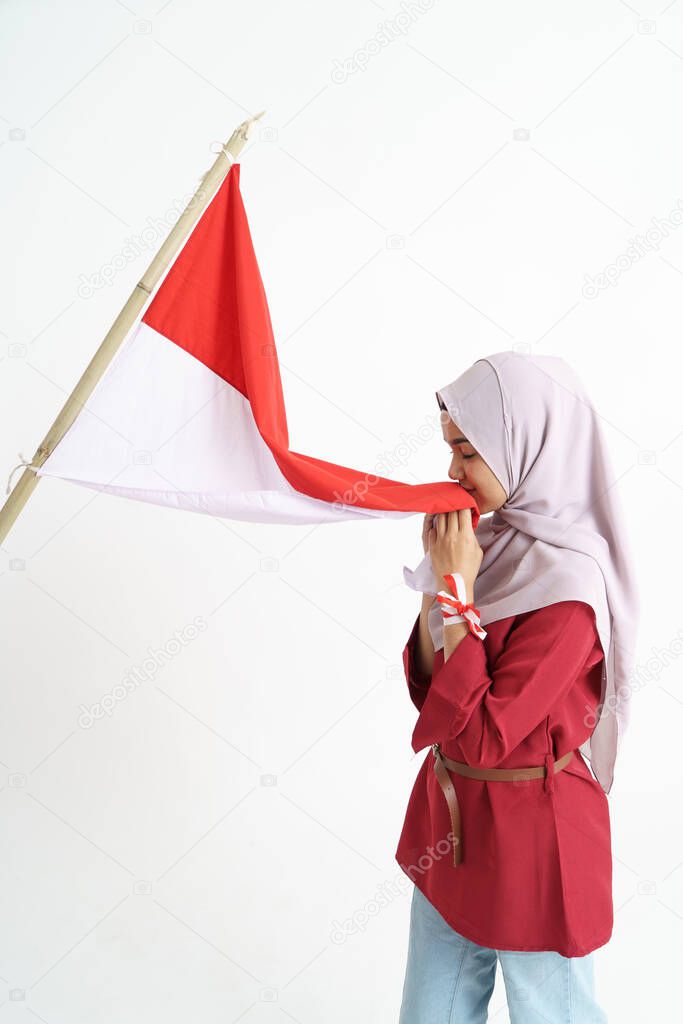 sian woman with scarf kissing red and white flag of indonesia
