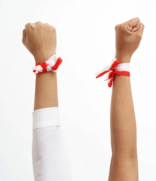 Hand put together wearing indonesian red and white ribbon on a wrist — Stock Photo, Image