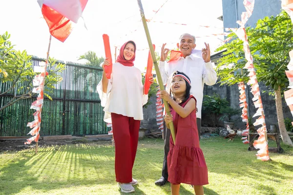 Kakek, nenek, dan cucu mengenakan pakaian merah dan putih — Stok Foto