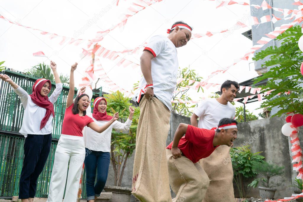 The audience supports participants in the Sack race during the Indonesian Independence Day celebration