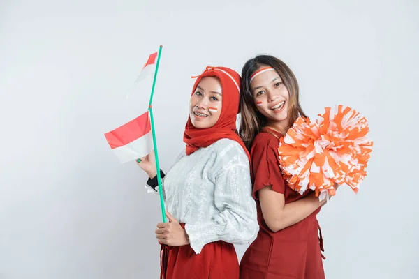 Två hijab ung kvinna leende och stå hålla indonesisk flagga med attribut — Stockfoto