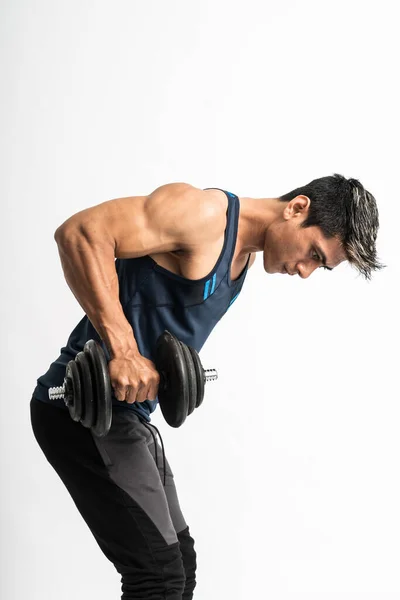 Asian young man lift dumbbell to train their back muscles and triceps — Stock Photo, Image