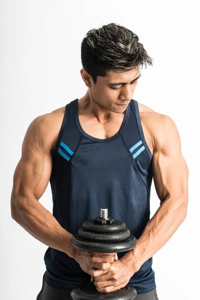 Young man wearing gym clothes lift the dumbbell with both hands — Stock Photo, Image
