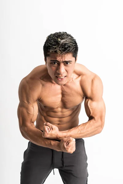 Asian young man showing a muscular body stand facing forward look the camera — Stock Photo, Image