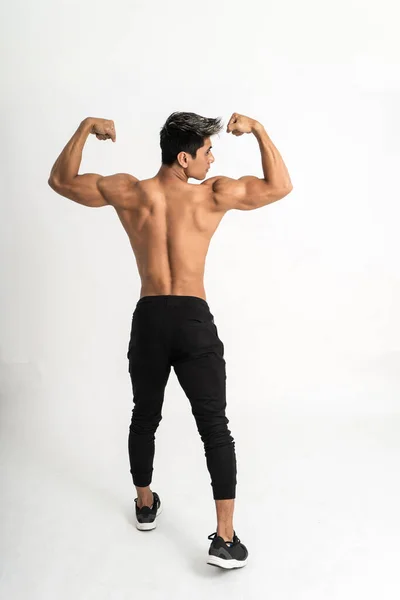 Full body image of young man showing muscular body stand facing back — Stock Photo, Image