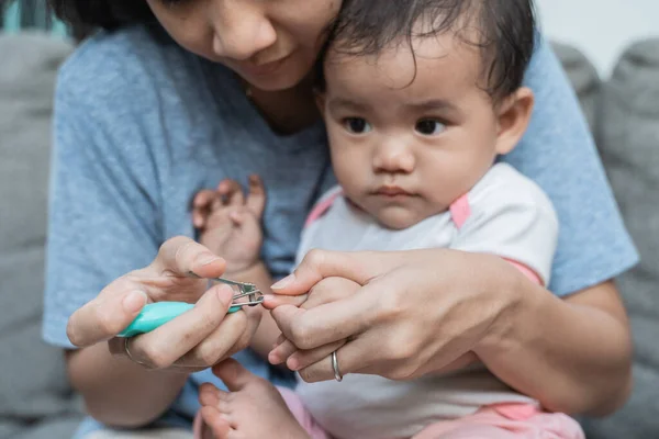 Closeup of a mother who takes care of her sons nails — Stock Photo, Image