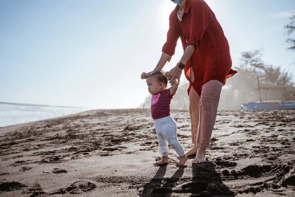 Bir annenin portresi oğluna yürümeyi öğretiyor. — Stok fotoğraf