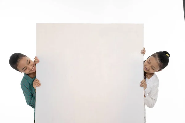 Happy two young girl holding empty white board — Stock Photo, Image