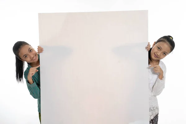 Happy two young girl holding empty white board — Stock Photo, Image