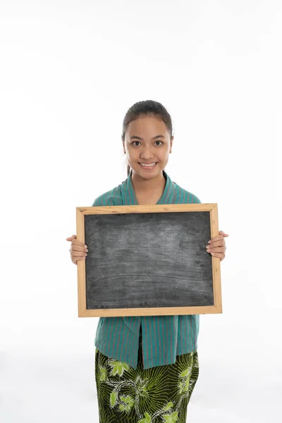 Beautiful young girl holding empty white board — Stock Photo, Image