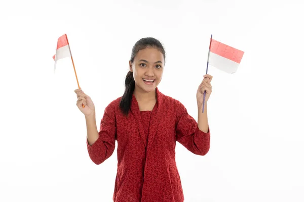 Wanita Indonesia meraih bendera merah dan putih. Mengenakan kebaya — Stok Foto