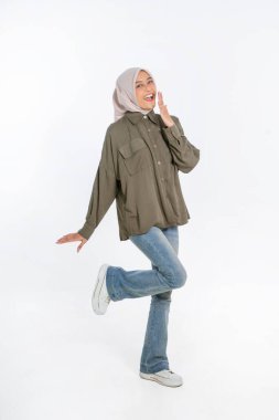 Keyifli bir kadın, günlük kıyafetlerle poz veriyor, hareketli bir kişilik sergiliyor..