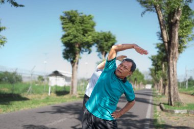 İki son sınıf öğrencisi sakin ve sakin bir ortamda esneme egzersizleri yapıyor.